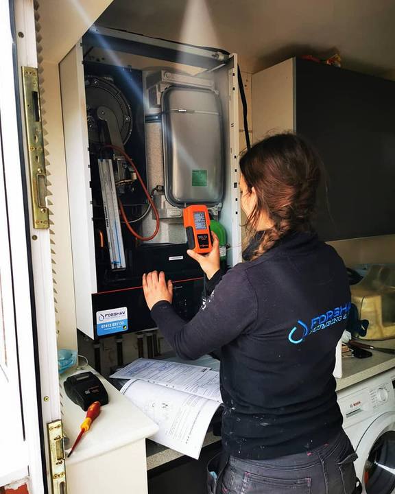 A Forshaw engineer testing a domestic boiler with a flue gas analyser